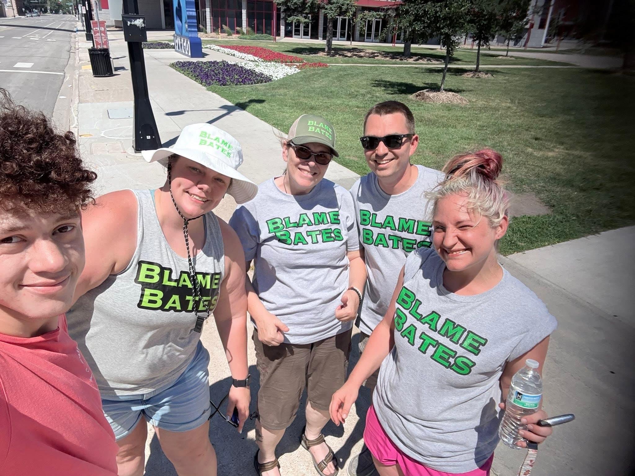Blame Bates team members in branded shirts walking together in downtown Fargo.